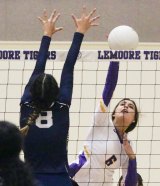 Lemoore's Alexis Ramponi scores against Sunnyside's Megan Hernandez Tuesday night in the Lemoore Event Center. The Tigers beat Sunnyside in four games.